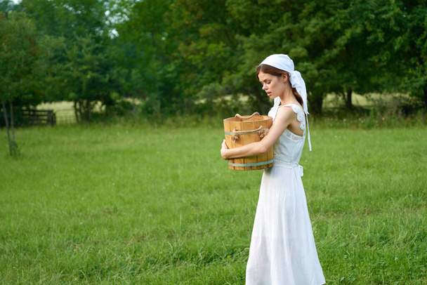 Woman in white dress countryside village nature ecology - Foto, Imagen