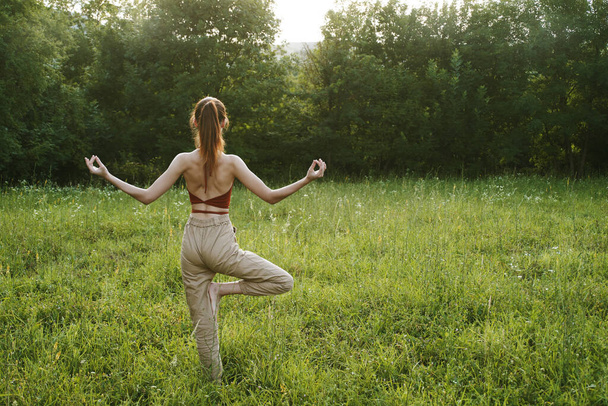 woman in a field outdoors summer meditation fresh air - Φωτογραφία, εικόνα