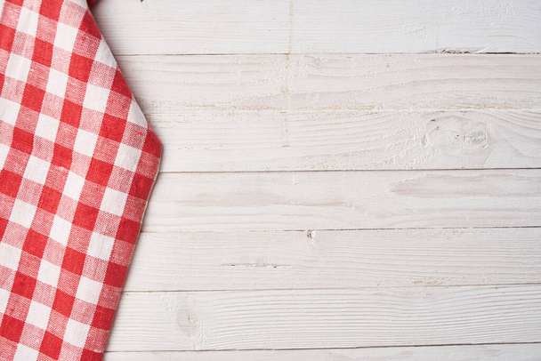 Red checkered tablecloth wooden background texture kitchen decoration - 写真・画像