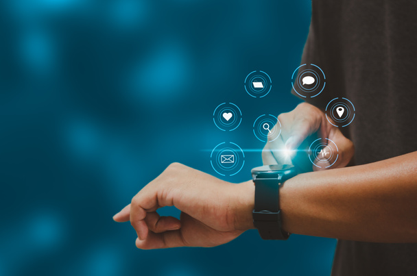 Man hand touching a smart watch virtual icon. Communication and use of modern Internet technology metaverse, Social Networking, online marketing, digital online. Concept technology. - Foto, Bild