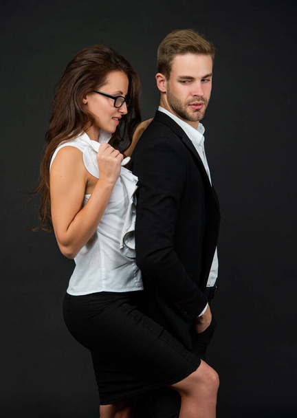 man and woman in glasses. business partners on black background. formal couple in love. - Zdjęcie, obraz