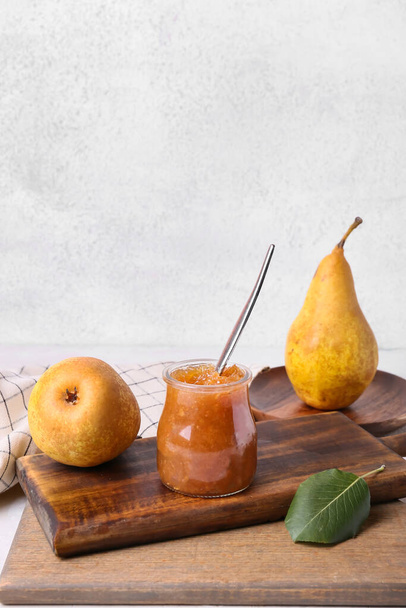 Glass jar of tasty pear jam on table - Photo, Image