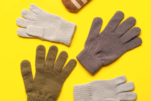 Different warm mittens on yellow background, closeup - Photo, Image