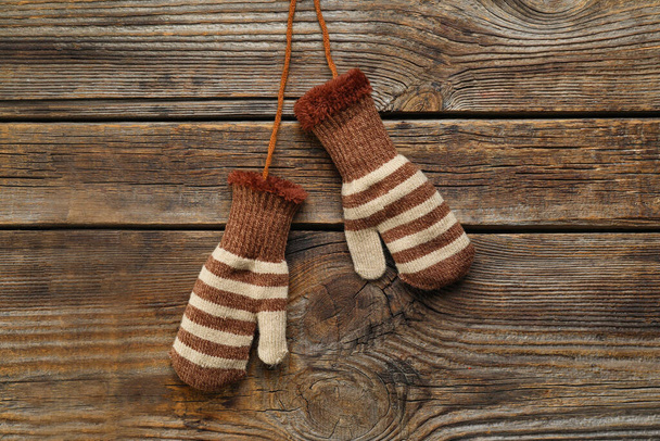 Warm mittens on wooden background - Fotó, kép