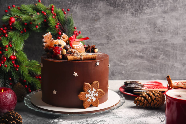 Composition with tasty Christmas chocolate cake on grey background - Photo, Image