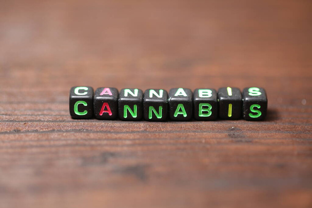 bracelet with multicolored letters inscription cannabis - Valokuva, kuva