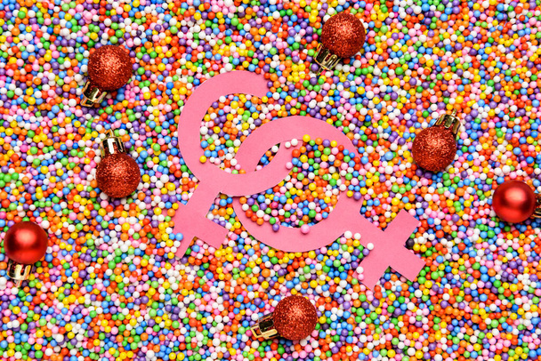 Symbolen van vrouw en kerstballen op regenboog achtergrond. LGBT-concept - Foto, afbeelding