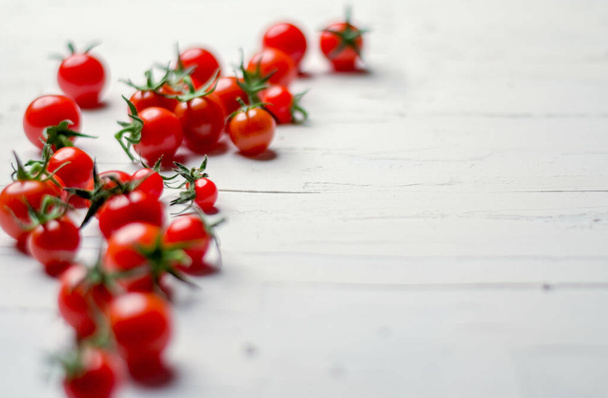 A closeup shot of a bunch of cherry tomatoes isolated on a white background - Фото, изображение