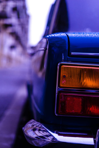 A closeup of an old blue Soviet Union car covered in rain droplets - Φωτογραφία, εικόνα