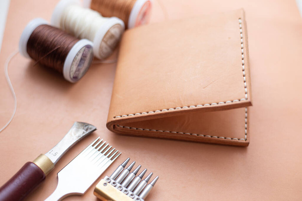 Genuine leather bifold money wallet with crafts tool craftmanship working - Fotografie, Obrázek