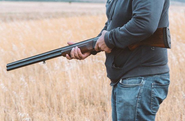Male hunter ready to hunt with hunting rifle.hunter Holds a rifle. - Valokuva, kuva