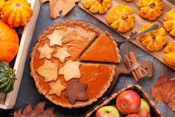 Homemade pumpkin look muffins, pie and various pumpkins. Top view flat lay - Photo, Image