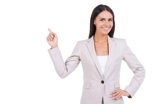 Businesswoman in suit pointing away - Foto, Imagen