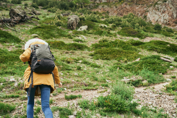 woman hiker with backpack mountains travel adventure freedom - Valokuva, kuva