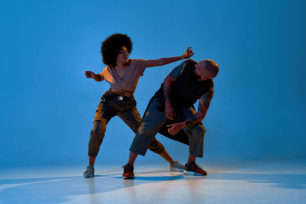 Young cool man and woman dancing hip hop dance - Fotó, kép
