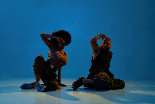 Multiracial man and woman dancing hip hop dance - Fotó, kép
