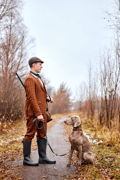beautiful hunting dog with owner during a hunting day. Autumn season, hunter. outdoors - Foto, Imagen