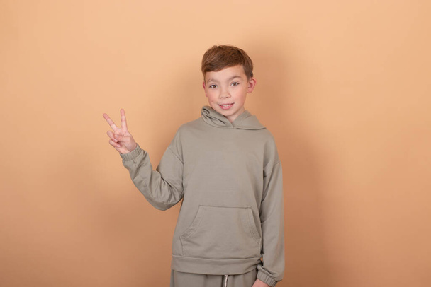 Teen boy portrait teenager isolated on brown background. emotions on face. feelings and facial expression concept. advertisement. copy free space for text - Foto, Imagen