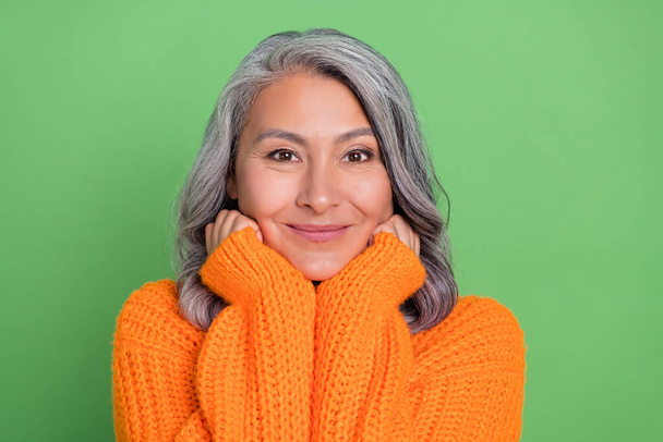 Photo of cute white hairdo old lady hands face wear sweater isolated on green background - Zdjęcie, obraz