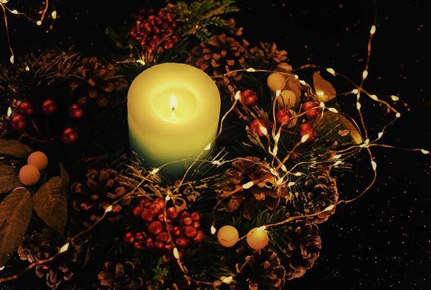Christmas wreath and candle. dark fantasy photo. - Foto, afbeelding