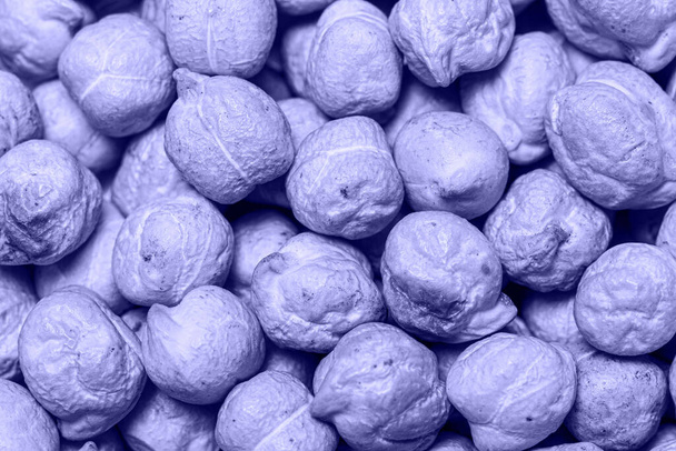 Macro photo of chickpeas, top view. Color of the Year 2022 - Very Peri. - Photo, Image