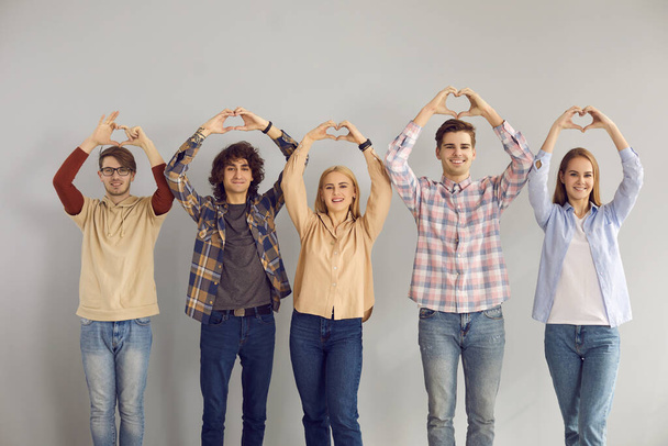 Group of teenage student showing love sympathy make heart gesture studio shot - Foto, Bild