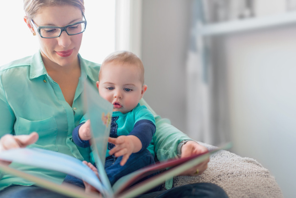 Cute baby reading with his mother - Photo, image
