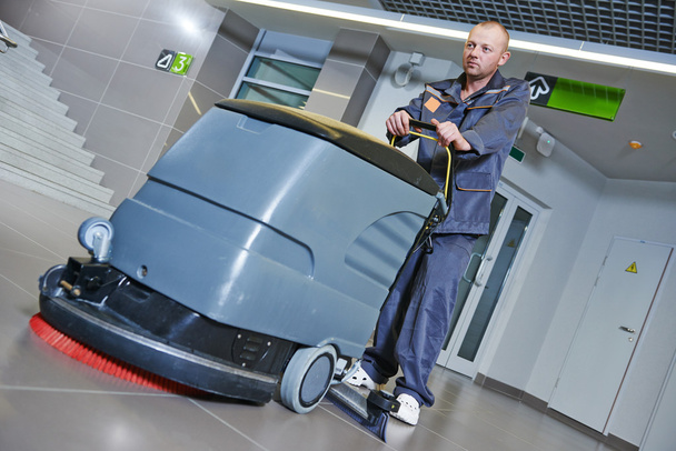 worker cleaning floor with machine - Photo, Image