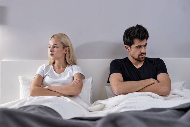 Young Couple Have Disagreement in Bedroom at Home. Quarrel in Young Family. - Valokuva, kuva