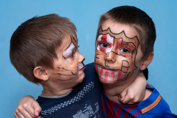 The brothers hug and look at the camera. Childrens with face painting - Fotoğraf, Görsel