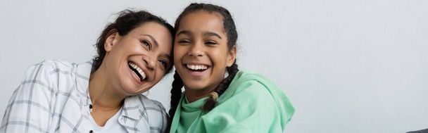 excited african american woman with teenage daughter laughing while spending time at home, banner - Fotoğraf, Görsel