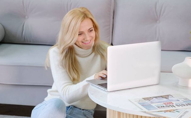 Image of young cheery happy positive cute beautiful business woman sit indoors in office using laptop computer. - Zdjęcie, obraz