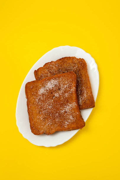 typical portuguese Christmas dessert fried bread with cinnamon on white dish - Foto, Imagem