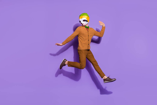 Full size photo of excited freaky sloth mask guy jumping have fun isolated on purple color background - Foto, afbeelding