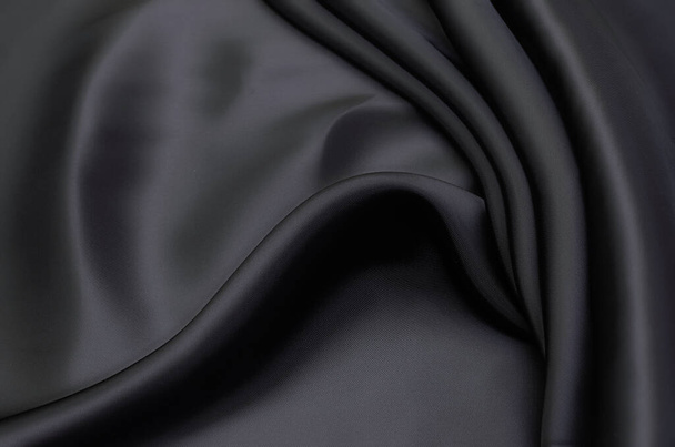Struttura di primo piano di tessuto grigio naturale o nero o stoffa dello stesso colore. Tessuto di cotone naturale, seta o lana o tessuto di lino. Sfondo tela nera. - Foto, immagini