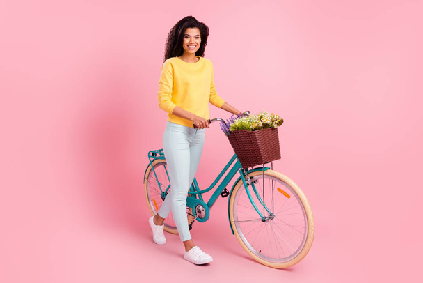 Full length body size view of pretty cheerful girl walking bike spring free time isolated over pastel pink color background - Fotografie, Obrázek