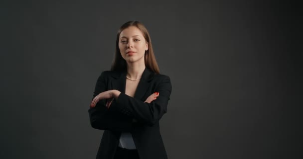 Mujer de negocios ambiciosa de confianza en traje negro mira a la cámara, las manos dobladas, pose cerrada, 4k Prores HQ - Metraje, vídeo