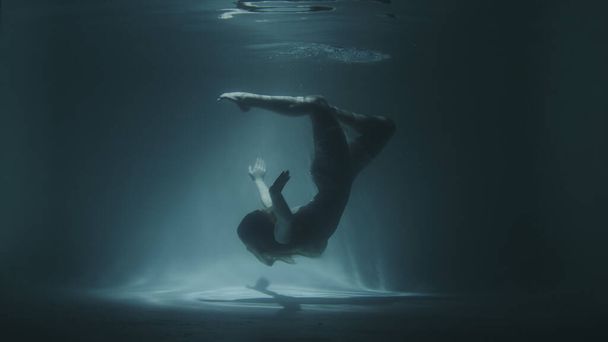 Unterwassergymnastik eines schönen Mädchens in einem weißen Kleid - Foto, Bild