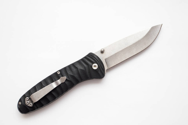 Folding hunting knife with black handle on white background. - Photo, Image
