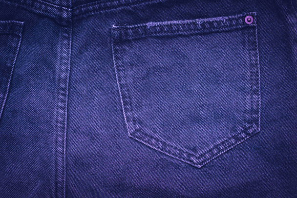 Jeans texture with pocket in Color of the Year 2022, Very Peri. Highly detailed closeup of violet jeans. Cool background. - Photo, Image