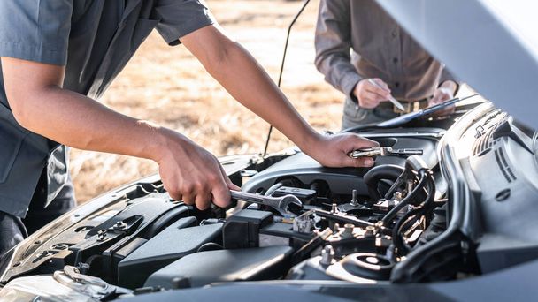 Technician team working of car mechanic in doing auto repair service and maintenance worker repairing vehicle with wrench, Service and Maintenance car check. - Photo, Image