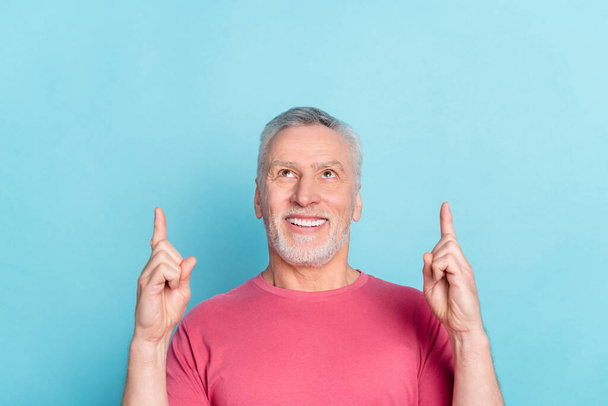 Photo portrait senior man looking pointing finger blank space up dreamy isolated pastel blue color background - Φωτογραφία, εικόνα