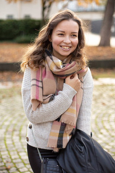 Portrait of smiling young european white woman with brown hair walking in autumn - Foto, Bild