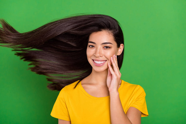Photo of charming happy pretty young woman hold hands face fly hair isolated on green color background - Φωτογραφία, εικόνα