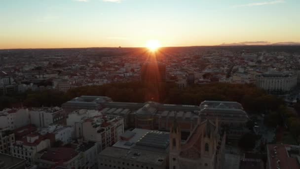 Backwards fly above town at sunset time. Revealing historic buildings and Parterre Garden in park. View against sun on horizon. - Footage, Video