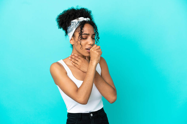 Young latin woman isolated on blue background coughing a lot - Photo, Image