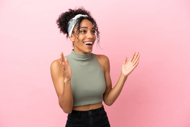 Young latin woman isolated on pink background with surprise facial expression - Foto, Imagen