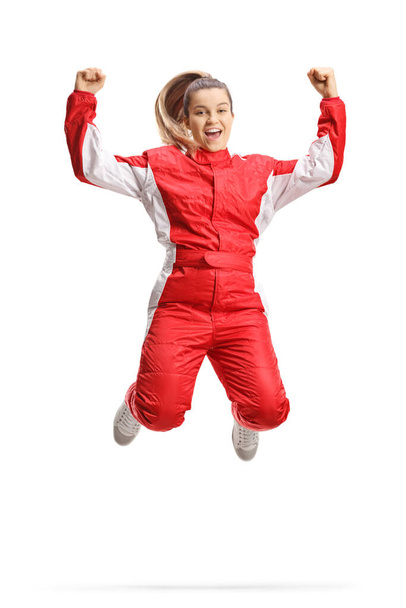 Female racer in a red suit jumping and gesturing happiness isolated on white background - Φωτογραφία, εικόνα