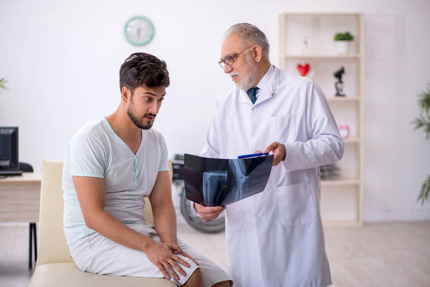 Young male patient visiting old male doctor radiologist - Photo, Image