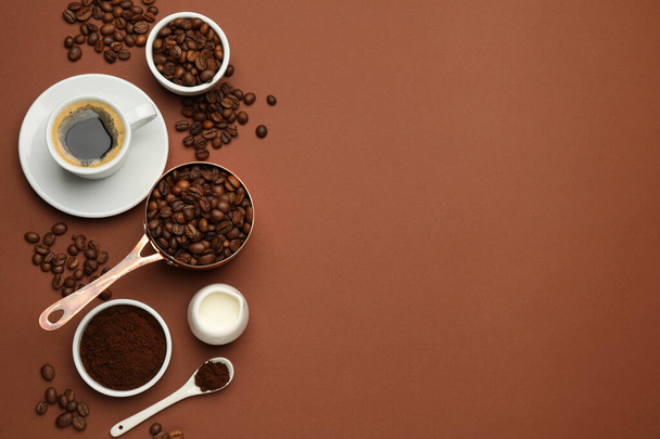 Flat lay composition with ground coffee and roasted beans on brown background, space for text - Foto, Bild